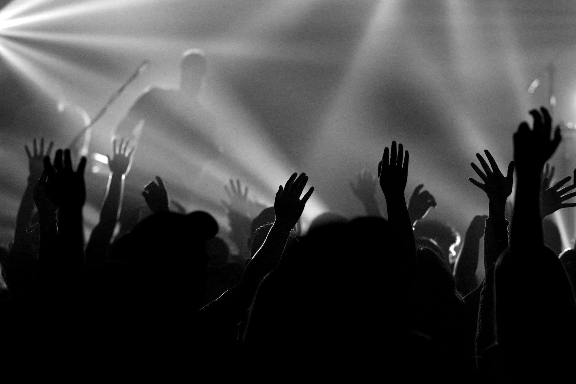 people jamming while man singing on stage